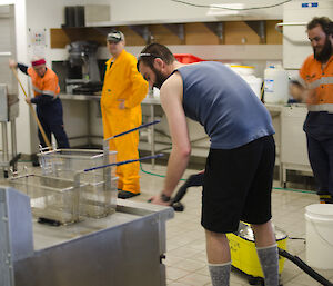 group of trades people in the the kitchen cleaning