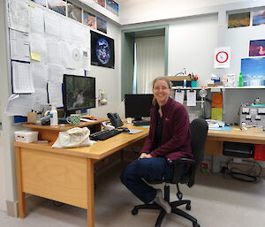 An expeditioner in her office in the meteorology building