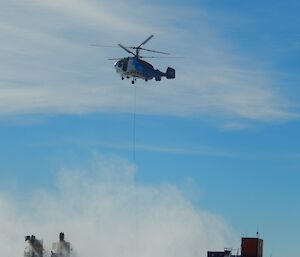 Helicopter places water container on the heli pad