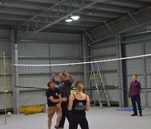 Expeditioners playing volleyball in the heli hanger