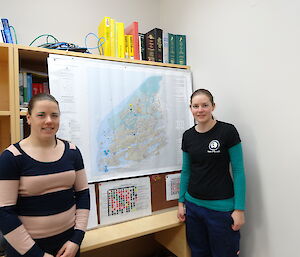 two expeditioners standing alongside map of Vestfold hills