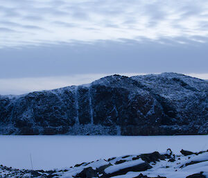 frozen lake and snow capped hills