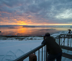 expeditioner taking a photo of the sunset