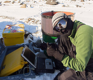 Expeditioner kneeling beside data cache