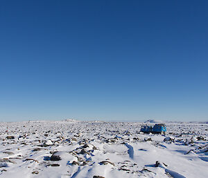 Wide photo of flat icy area blue Hägg in the distance