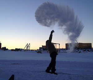 Expeditioner throwing boiling water in the air and watching it disappear