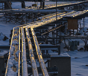 Sunset colours on icy station pipes