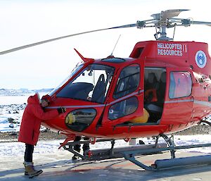 Expeditioner hugging a helicopter