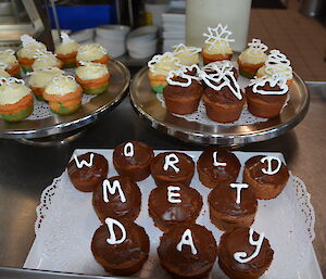 Cup cakes spelling out World Met day