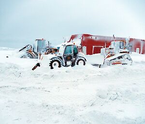 Machinery half buried in snow