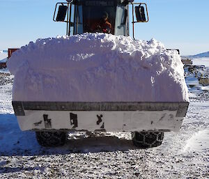 JCB vehicle with bucket full of snow