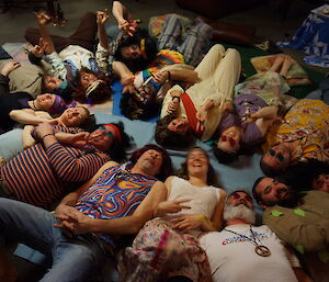 Expeditioners wearing hippy clothes in a circle