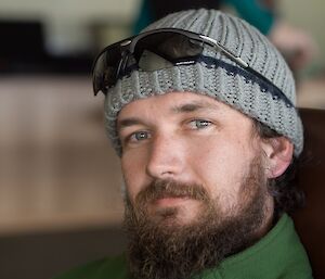 Close up photo of a male expeditioner with a bushy brown beard and beanie hat
