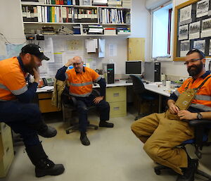 Three expeditioners looking like the are deep in thought