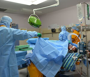Expeditioners in medical surgery during training scenario