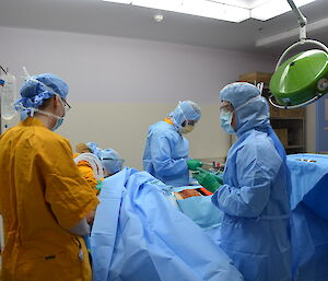 Expeditioners in surgery preparing a patient