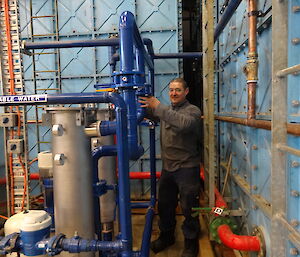 Expeditioner standing next to two large water filters