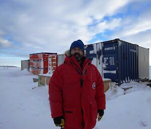 Expeditioner standing in front of containers