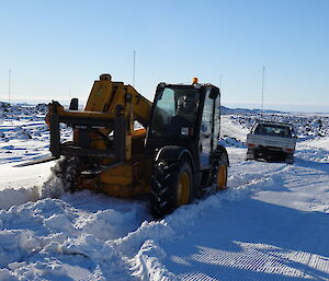JCB arrives to pull bogged ute from deep snow