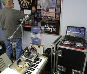 Expeditioner in a radio studio playing darts