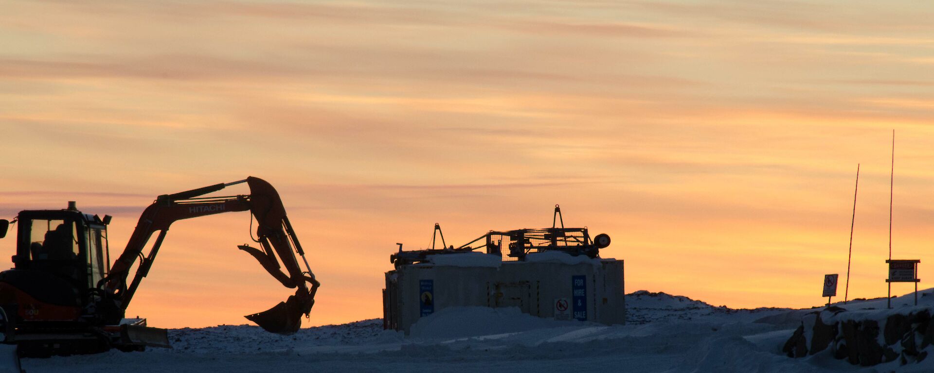 Sunset with a digger in the foreground