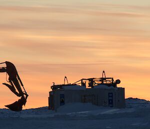 Sunset with a digger in the foreground