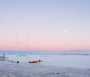 Soft colours of a sun setting and full moon