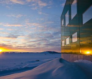 Sunset relection on large green building