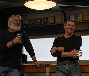 Two expeditioners standing next to a snooker table