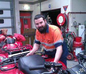 Expeditioner standing alongside quad bikes