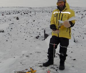 Expeditioner standing next to measurement stick