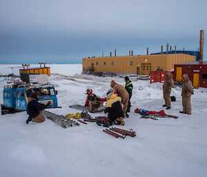 Expeditioners with recovery gear laid out on the ground