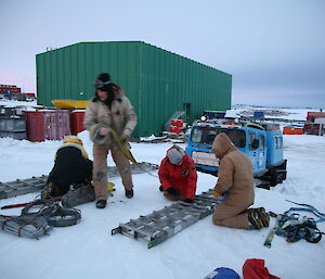 Expeditioners setting up cables, recovery tracks and gear in preparation