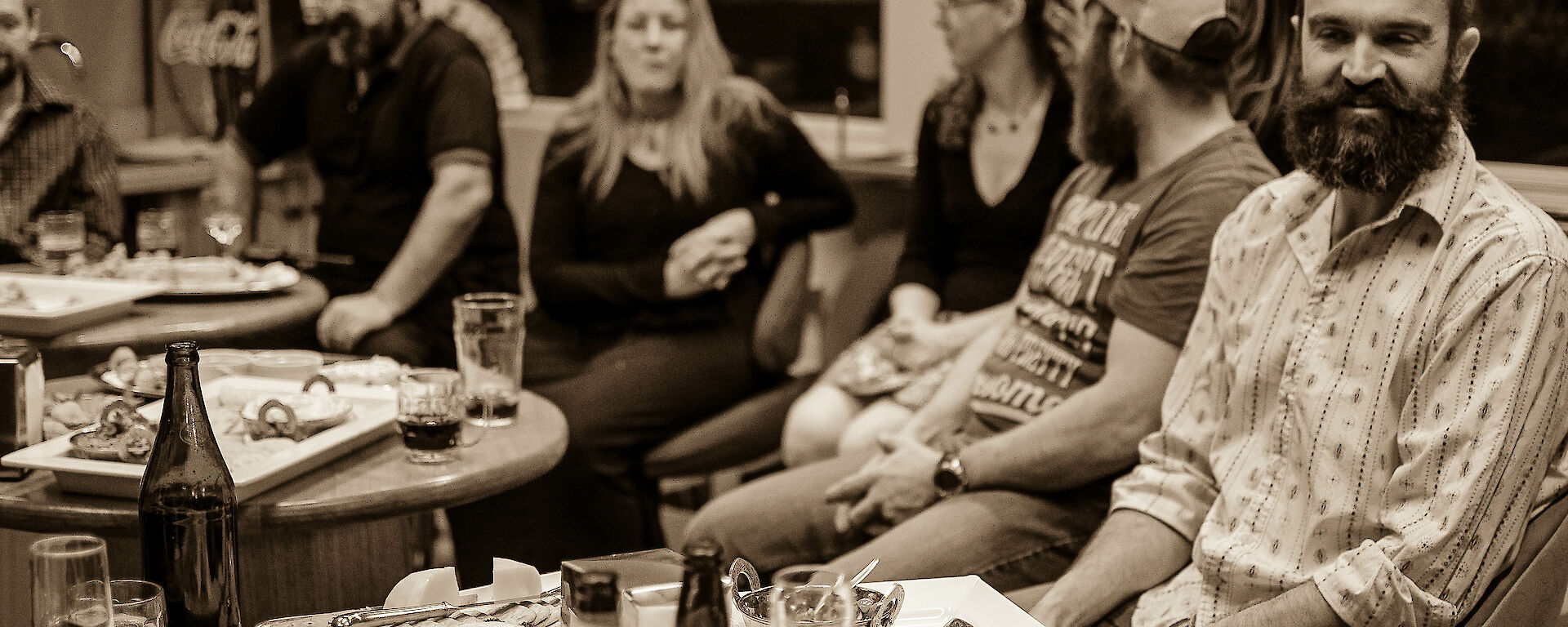 Group of expeditioners in bar enjoying a few drinks and canapes