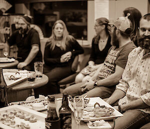 Group of expeditioners in bar enjoying a few drinks and canapes