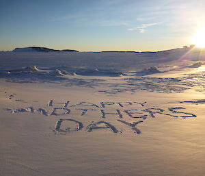 The words Happy Mother’s Day written in the snow