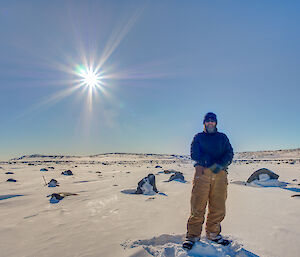 Expeditioner in the field surrounded by snow and rocks