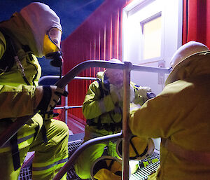 Expeditioners wearing fire fighting equipment