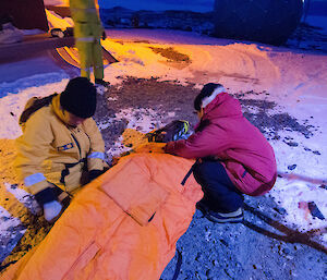 Expeditioners outside building attending to patient