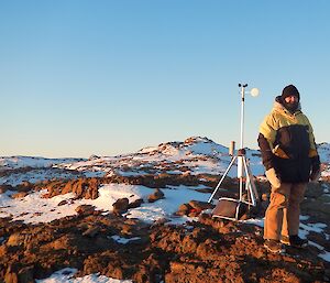 Expeditioner standing next to camera equipment