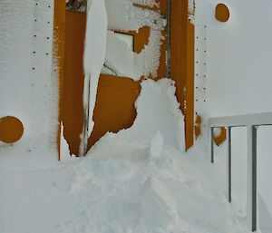 External doorway half blocked by heavy snow fall