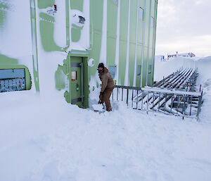 Expeditioner shovelling snow