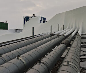 A line of station pipes covered in heavy snow