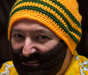 Expeditioner wearing a knitted beanie with a knitted beard attached