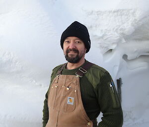 Close up photo of bearded expeditioner against snow backdrop