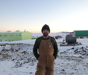 Expeditioner with the sea ice and station in the background