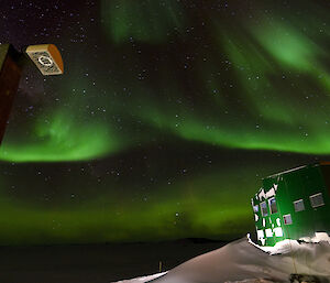 Bright green aurora in the early morning sky over station
