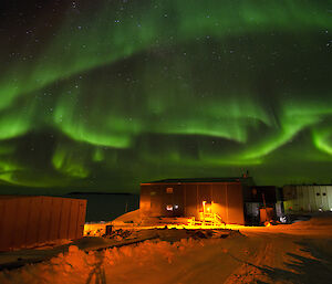 Swirling green aurora above station