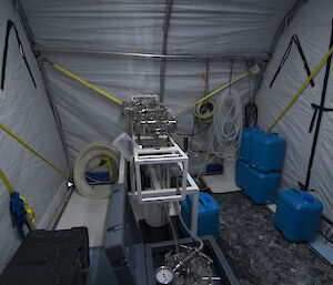 Blue tubs and science equipment inside the small tent