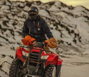 Expeditioner riding a quad on snow